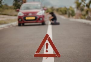 The car is parking on the shoulder of the road, waiting for roadside assistance
